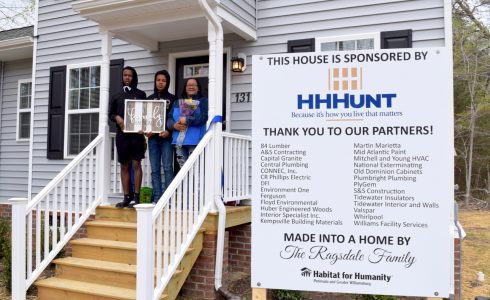 Family standing in front of HHHunt Sponsored home in partnership with Habitat for Humanity.