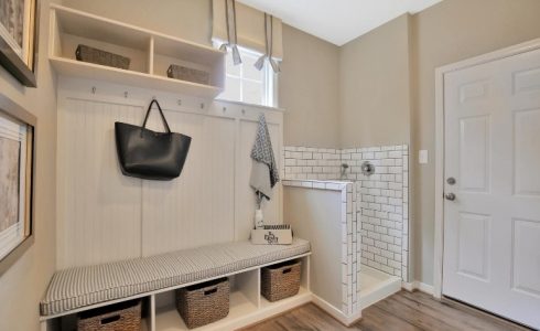 Model home foyer area with pet wash station with white tile.