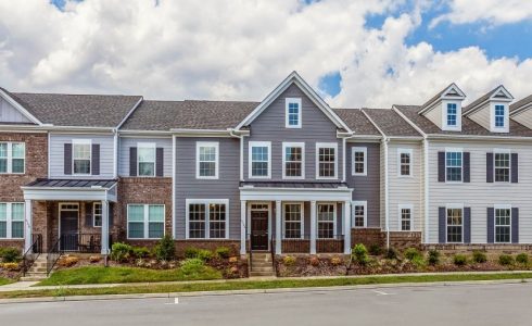 Row of HHHunt Homes townhomes with wooded view