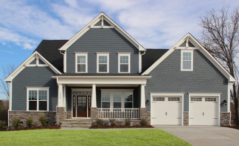 HHHunt Homes Willoughby Crawford model home with two-car garage gray exterior siding