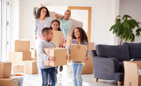 African American family moving into home with boxes