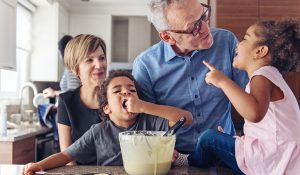 parent and grandparent with children baking in kitchen